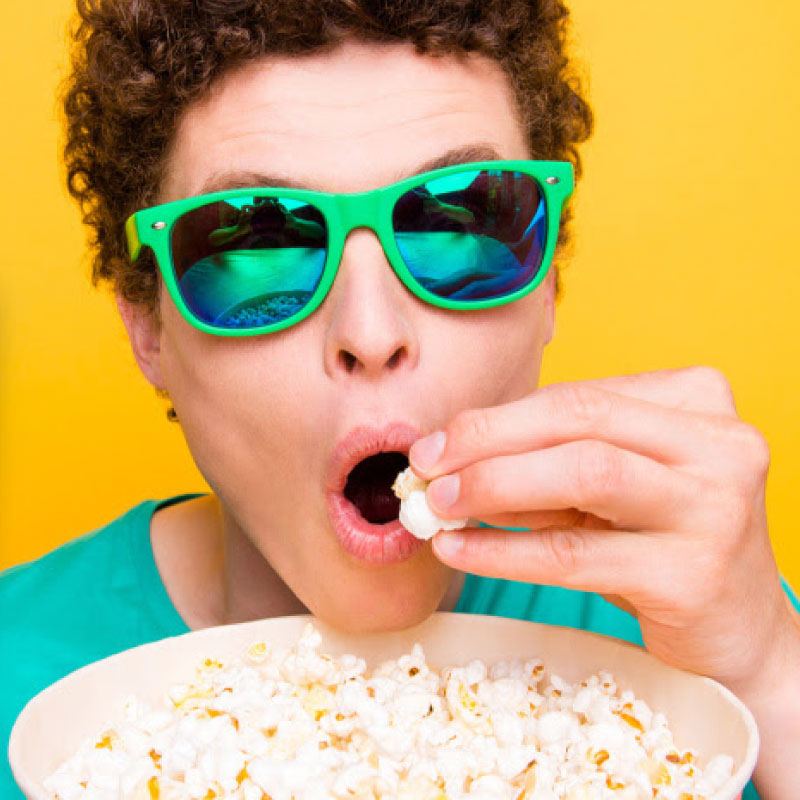 Man with sunglasses eating popcorn