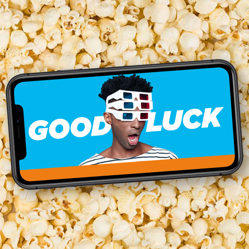 Mobile phone screen showing man with 3D glasses saying good luck